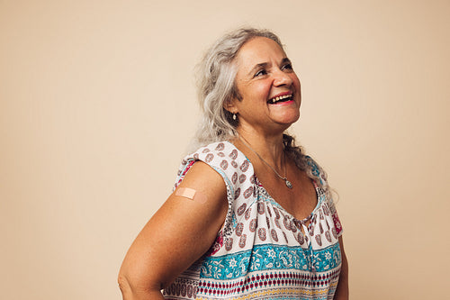 Senior female smiling after getting a vaccine