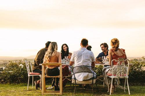 Group of young friends having dinner party