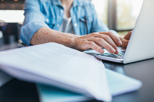 Student working on laptop at library