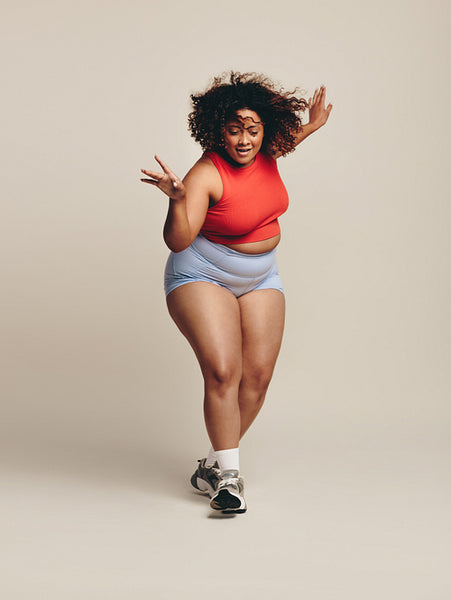 Sporty young woman moving her body in an active dance workout