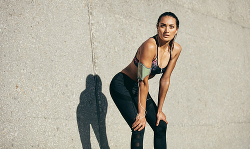 Young athletic woman taking a break from training