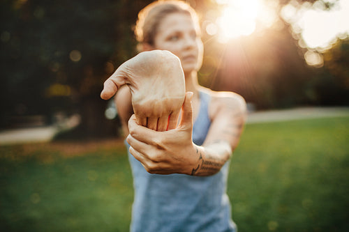 Fitness female stretching at the park.