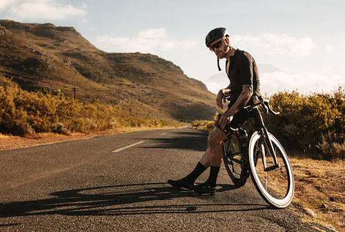 Professional cyclist taking a break