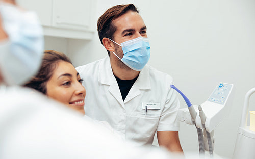 Happy dentist and female patient