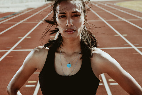 Sportswoman on stadium race track
