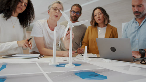 Business woman with industrial design expertise leading her team on a windmill project