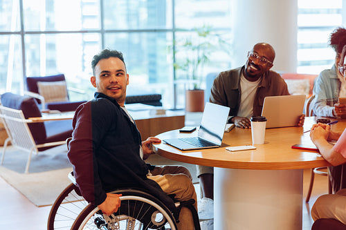 Friends collaborate at a round table in office