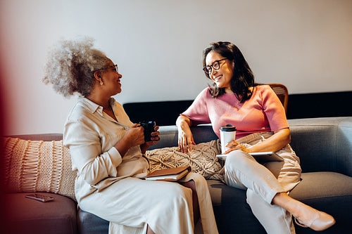 Two teammates share a lighthearted work conversation