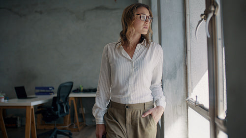 Smiling businesswoman in a small office
