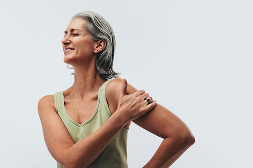 Strong mature woman wearing smart ring in studio portrait