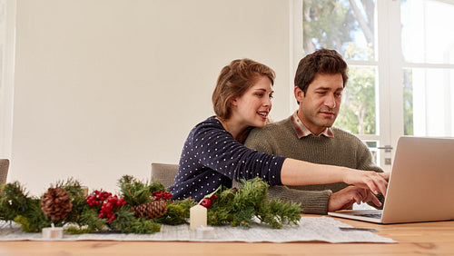Couple doing online shopping and buying presents for christmas