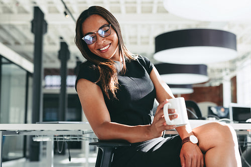 Successful businesswoman smiling in her office