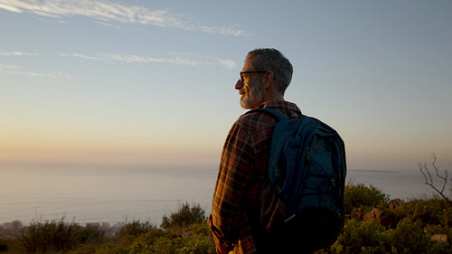 Hiker standing on a hill enjoying nature