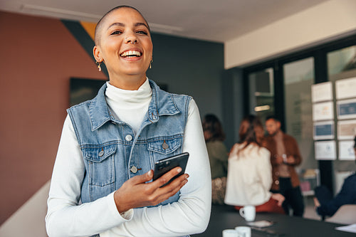 Young businesswoman smiling cheerfully in a boardroom