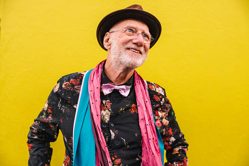 Happy senior man looking away thoughtfully