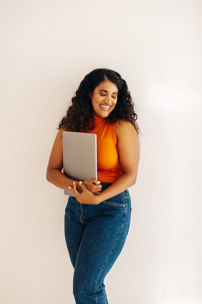 Successful female entrepreneur standing against a wall