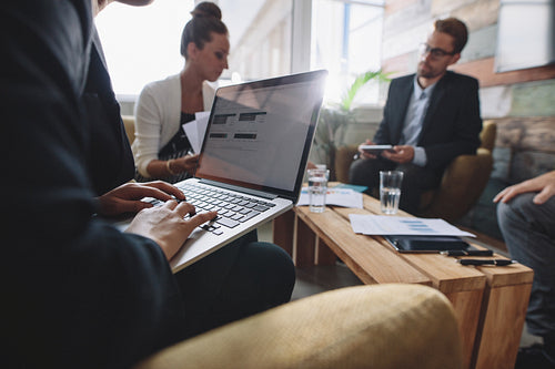 Businesswoman working on laptop during meeting