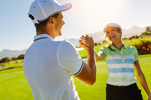 Golfers shaking hands at golf course
