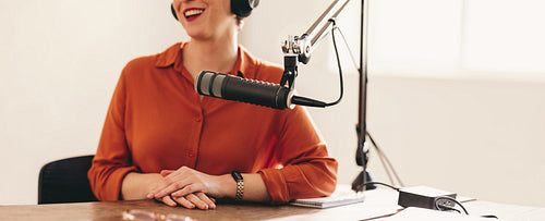 Happy woman appearing as a guest on a radio show