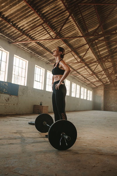 Female taking rest after physical training at cross workout space