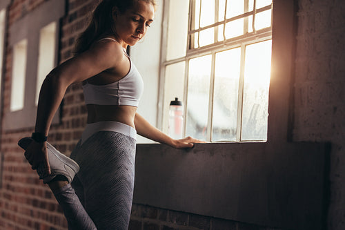 Healthy woman doing warmups at gym