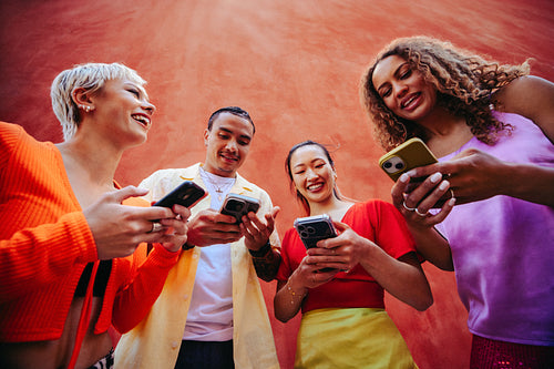 Social media influencers create content with smartphones outdoors together