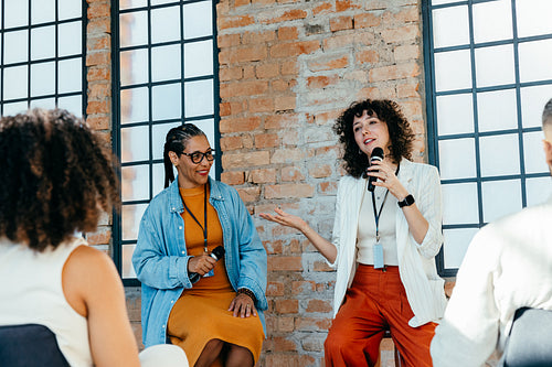 Women discussing leadership in a seminar at a modern office setting