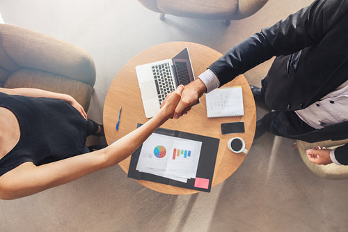 Businesspeople shaking hands after a successful meeting