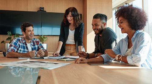 Coworkers discussing in meeting room at creative office