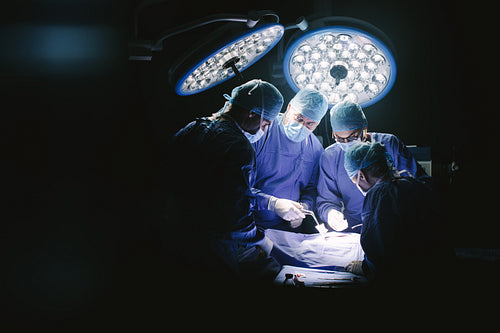Group of surgeons in hospital operating theater