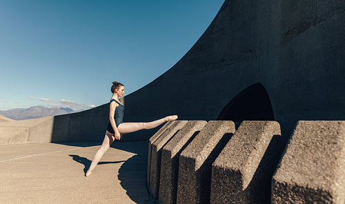 Female ballet dancer warming up before the practice