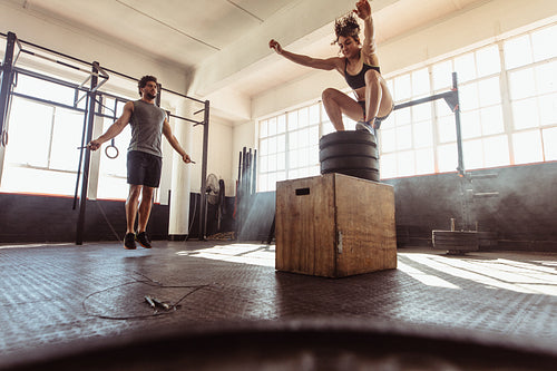 Young couple training hard at the gym