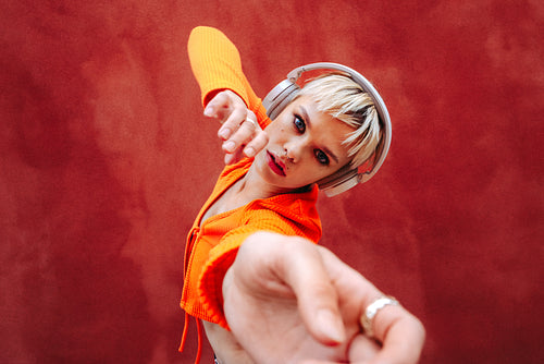 The music flows through her body as she listens through her headphones