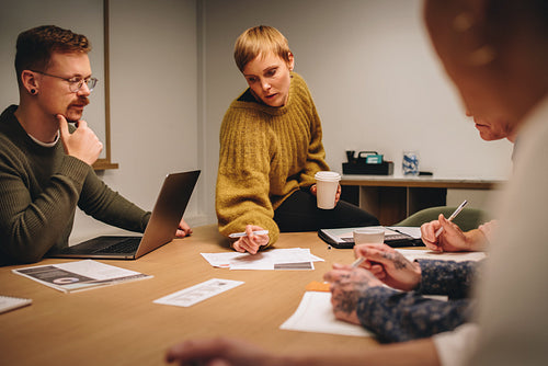 Woman discussing creative ideas with team