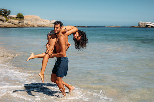 Tourist couple having fun enjoying on the beach