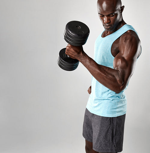 Bodybuilder using heavy dumbbell