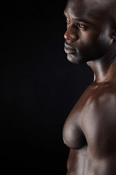 Man standing shirtless in the studio