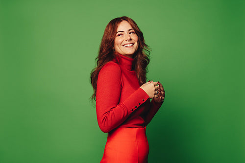 Happy woman with trendy style against green background
