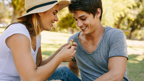 Couple on picnic sitting in park