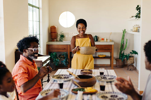 Brazilian family gathering for lunch in their kitchen