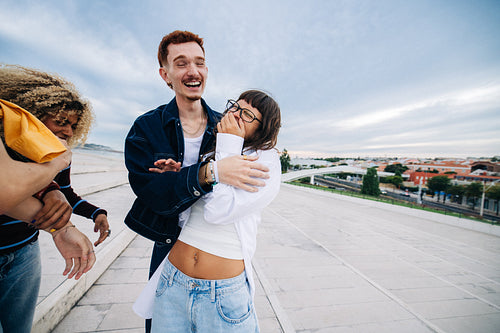 Friends laughing and hugging in a joyful moment