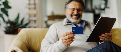 Shopping senior man completes a secure payment at home