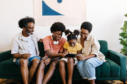 Brazilian family using a tablet for entertainment at home