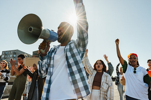 Diverse group of activists rallying together with determination and unity
