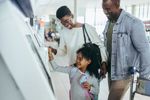 Family doing self check in at airport