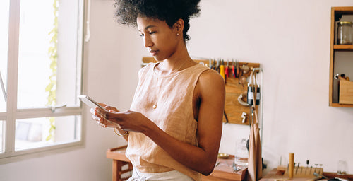 Jewelry studio owner using phone