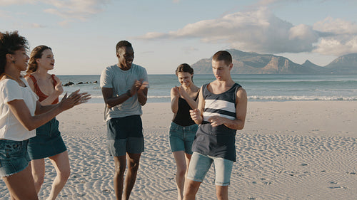 Friends dancing and enjoying on the beach