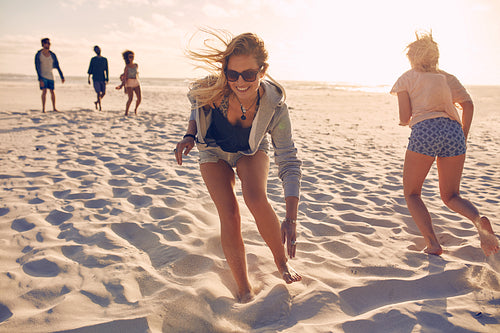 Friends playing games on the beach