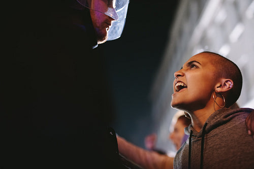 Woman demonstrating against police violence at night