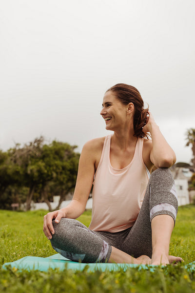 Smiling woman enjoying fitness session in park